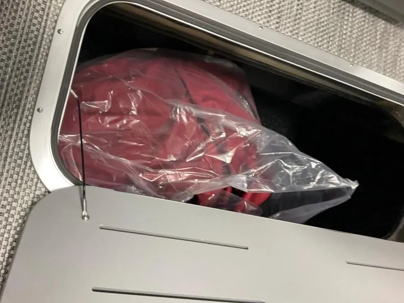 Slide: The Image of Storage compartment in 2024 Bennington 20 SVSR SPS boat with red item inside. - 9