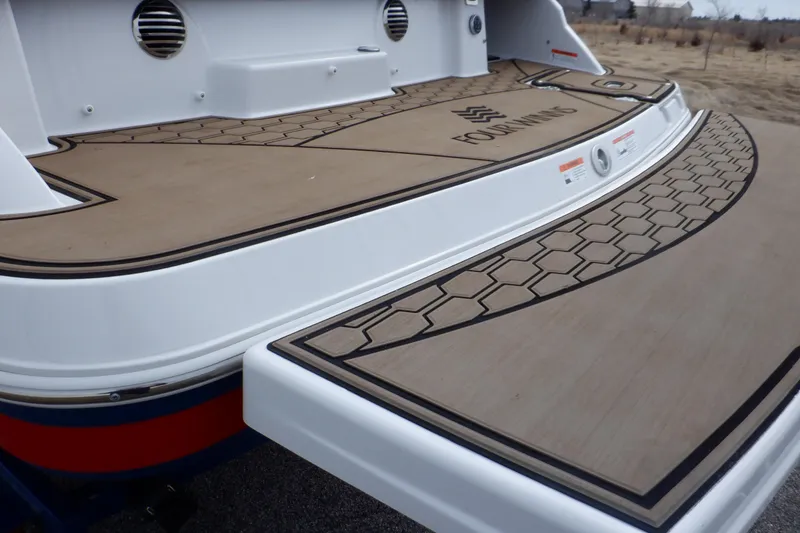 Slide: The Image of 2018 Four Winns HD200 boat deck with stylish wood finish and logo detailing. - 11
