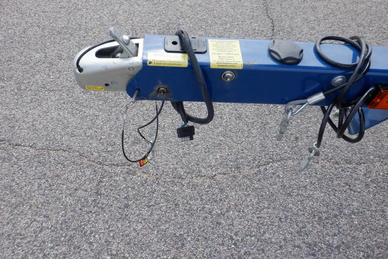 Slide: The Image of Trailer hitch of a 2018 Four Winns HD200 boat on asphalt surface. - 17