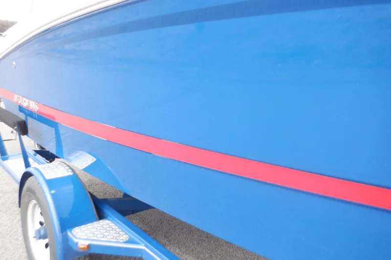 Slide: The Image of 2018 Four Winns HD200 boat with blue hull and red stripe on trailer. - 22