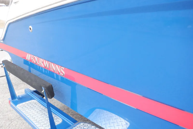 Slide: The Image of 2018 Four Winns HD200 boat with blue and red exterior detailing. - 23