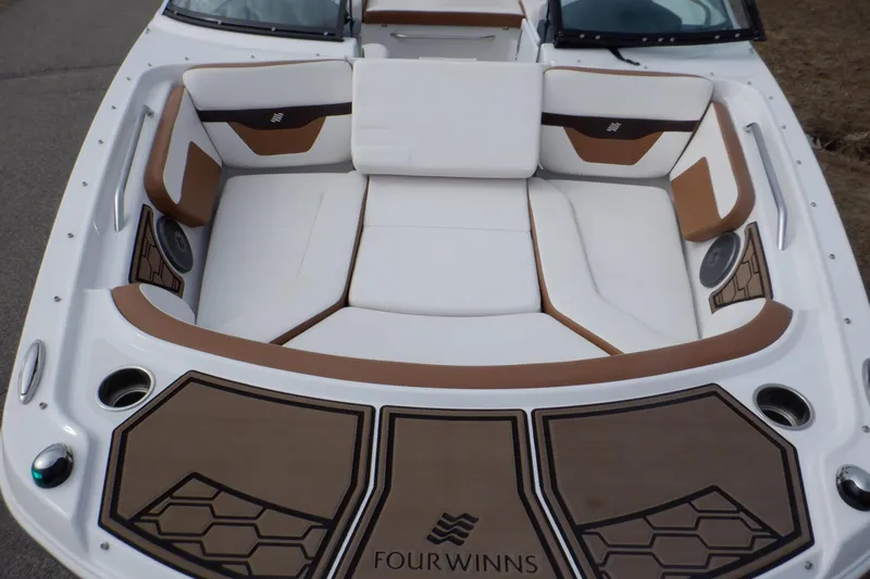 Slide: The Image of 2018 Four Winns HD200 boat interior with white and brown seating. - 3
