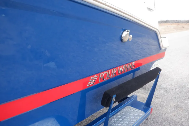 Slide: The Image of 2018 Four Winns HD200 boat, blue with red accents, rear view. - 30
