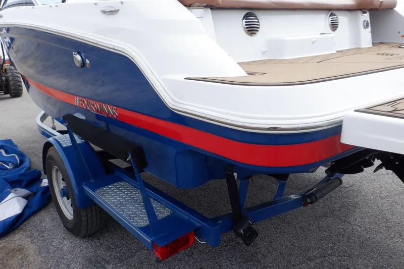 Slide: The Image of 2018 Four Winns HD200 boat on trailer, featuring blue and red accents. - 32