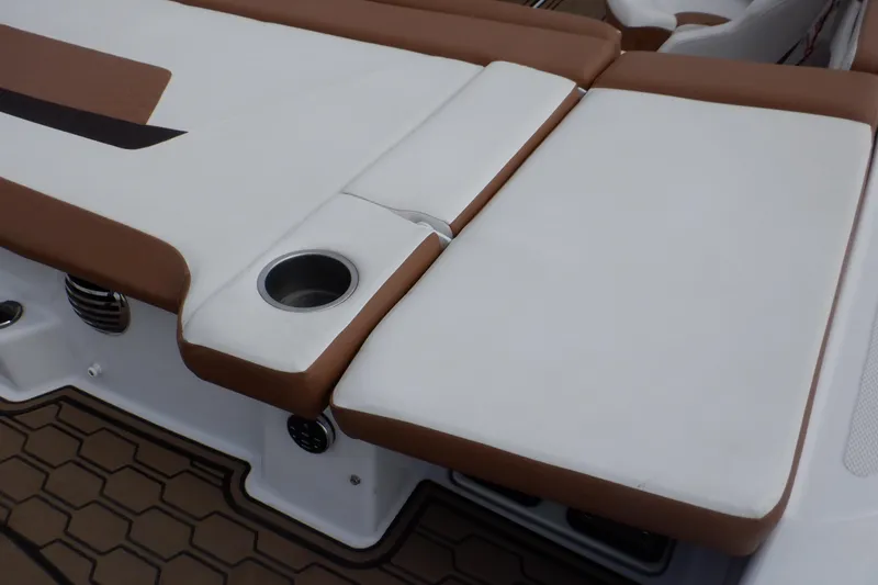 Slide: The Image of 2018 Four Winns HD200 boat interior with brown and white seating, featuring a built-in cup holder. - 35