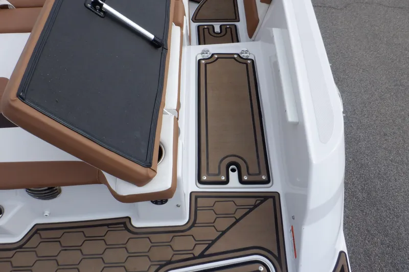 Slide: The Image of 2018 Four Winns HD200 boat interior with brown and white seating and flooring. - 36
