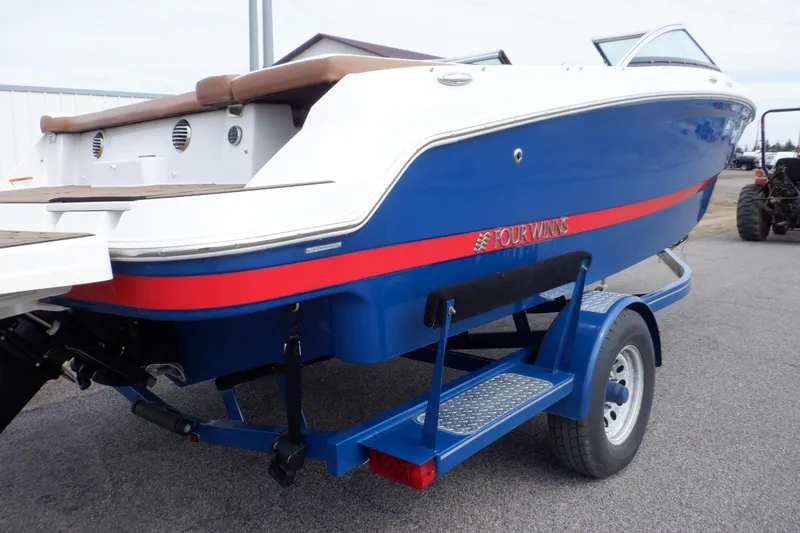 Slide: The Image of 2018 Four Winns HD200 boat on trailer, blue and white with red stripe. - 4