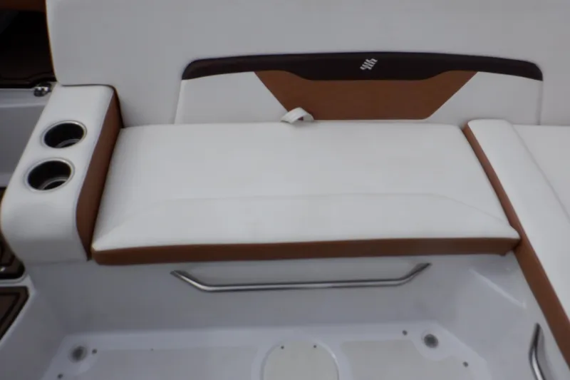 Slide: The Image of 2018 Four Winns HD200 boat interior with white and brown seating and cup holders. - 40