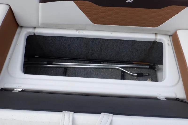 Slide: The Image of Storage compartment of 2018 Four Winns HD200 boat with tools inside. - 41