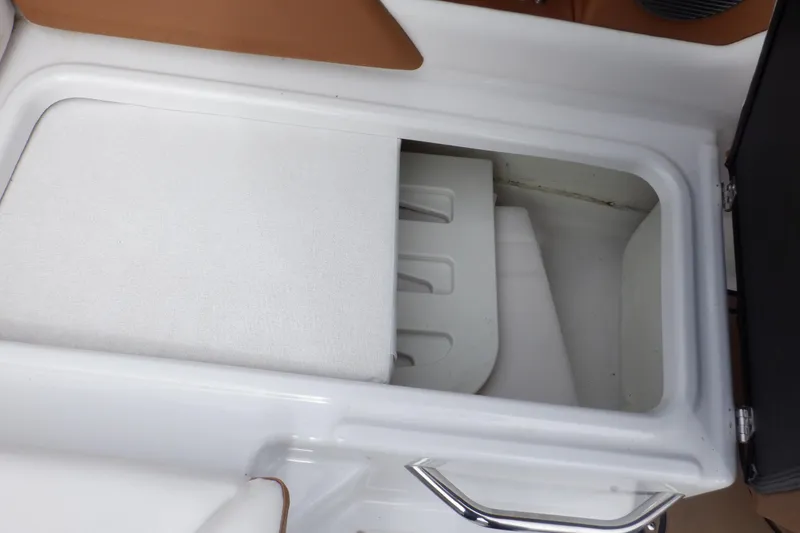 Slide: The Image of Storage compartment in 2018 Four Winns HD200 boat, featuring white interior and metal handle. - 42