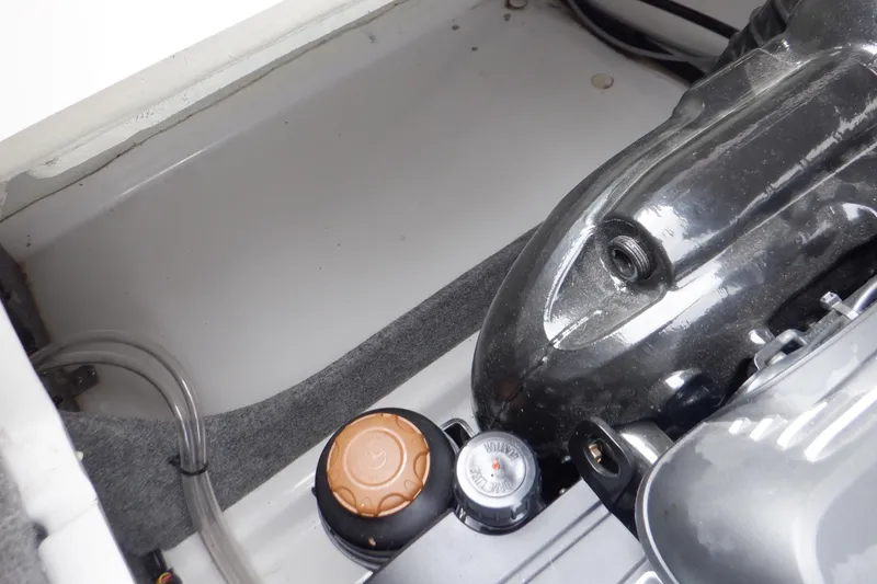 Slide: The Image of Engine compartment of a 2018 Four Winns HD200 boat, showing engine components and cap. - 45