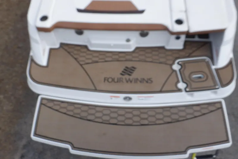 Slide: The Image of 2018 Four Winns HD200 boat deck with logo and textured flooring. - 6