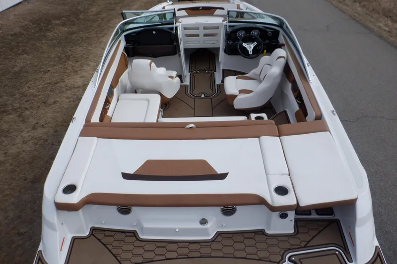 Slide: The Image of 2018 Four Winns HD200 boat interior with brown and white seating, steering wheel, and dashboard. - 7