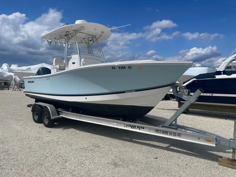 Slide: The Image of 2017 Regulator 23 FS Center Console boat on trailer under blue sky. - 1