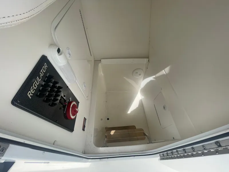 Slide: The Image of 2017 Regulator 23 FS Center Console interior with control panel and storage space. - 14