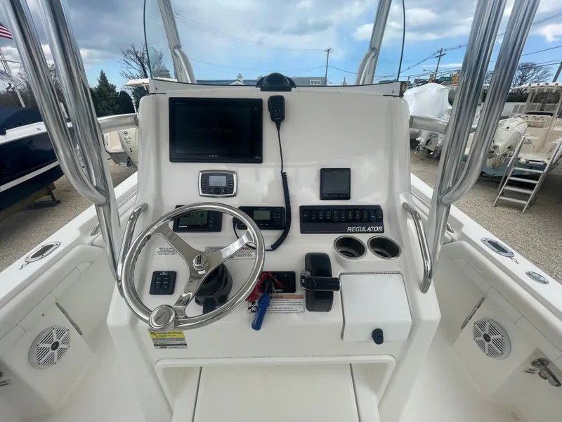 Slide: The Image of 2017 Regulator 23 FS Center Console dashboard with steering wheel and electronic controls. - 16