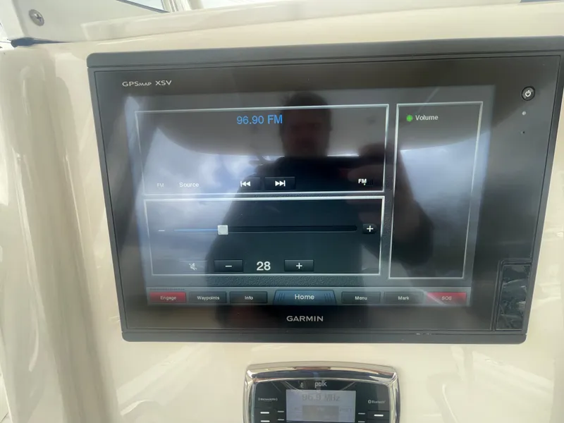 Slide: The Image of Garmin GPS display on 2017 Regulator 23 FS boat showing FM radio controls. - 22