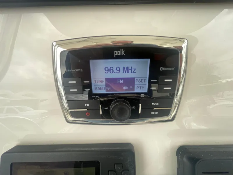 Slide: The Image of Polk audio system displaying 96.9 MHz in a 2017 Regulator 23 FS Center Console. - 26