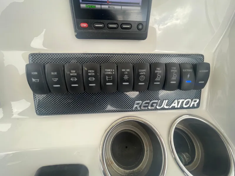 Slide: The Image of Control panel of a 2017 Regulator 23 FS boat with labeled switches. - 28