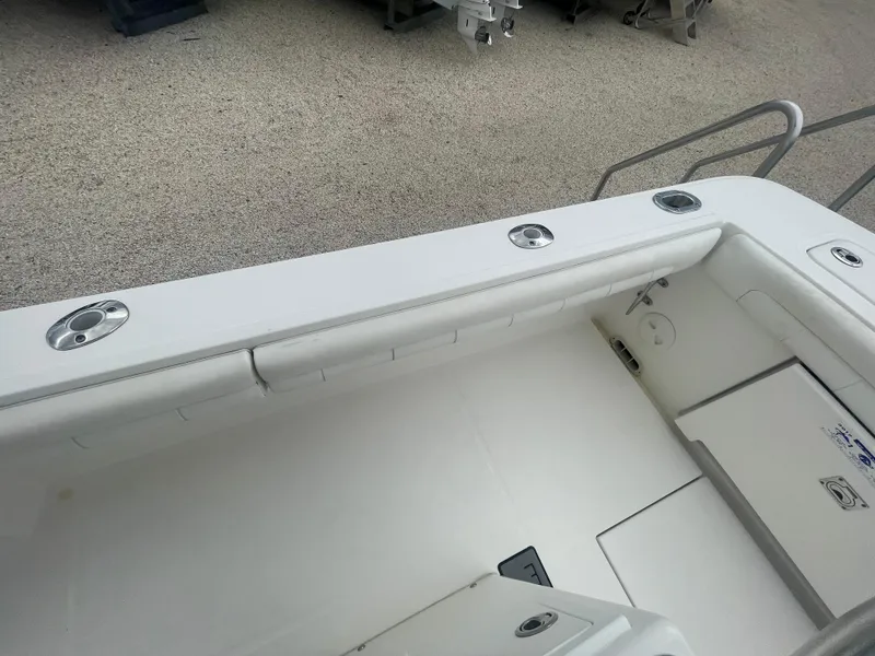 Slide: The Image of 2017 Regulator 23 FS boat interior with white seating and storage compartments. - 35