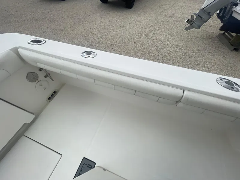 Slide: The Image of 2017 Regulator 23 FS boat interior with white seating and rod holders. - 36