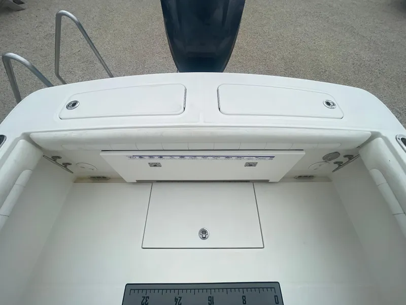 Slide: The Image of 2017 Regulator 23 FS boat deck with storage compartments and ruler. - 37