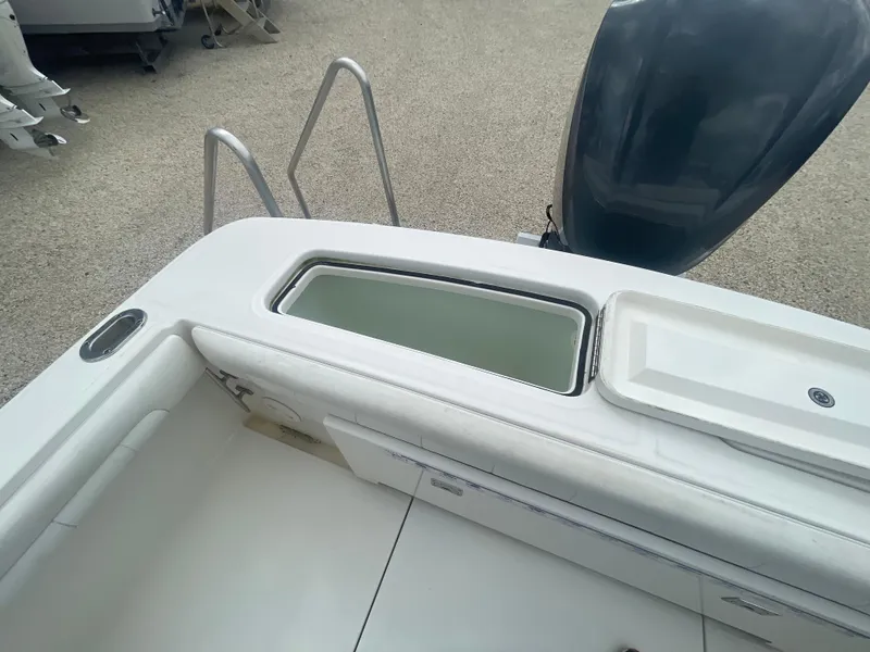 Slide: The Image of 2017 Regulator 23 FS boat interior with storage compartment and engine view. - 39