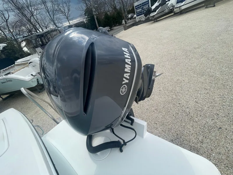 Slide: The Image of Yamaha outboard motor on a 2017 Regulator 23 FS boat, parked outdoors. - 44