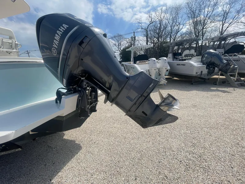 Slide: The Image of 2017 Regulator 23 FS Center Console with Yamaha outboard motor in a boatyard. - 46