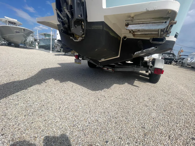 Slide: The Image of 2017 Regulator 23 FS Center Console boat on a trailer, rear view. - 50