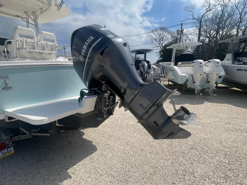 Slide: The Image of 2017 Regulator 23 FS Center Console with Yamaha outboard motor in a boatyard. - 7