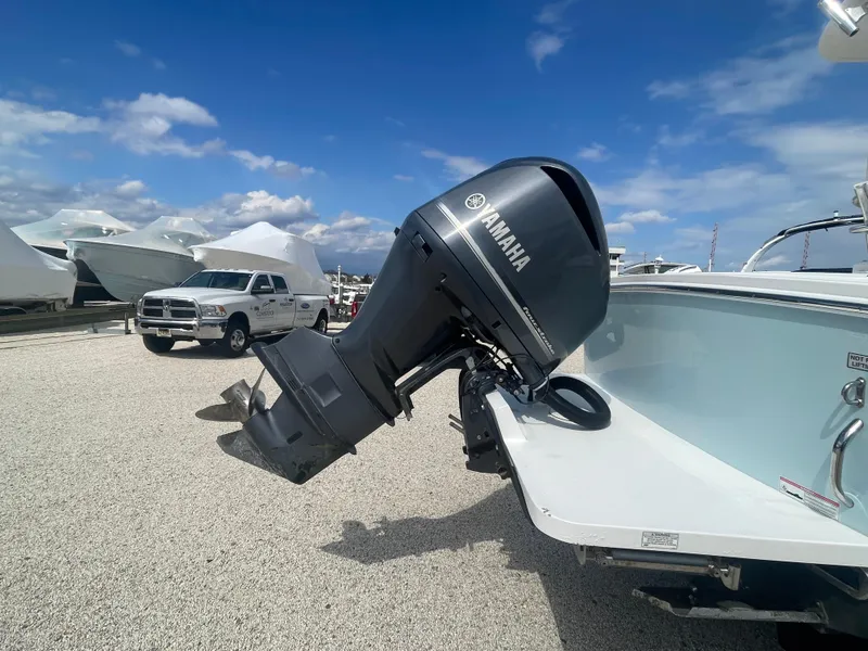 Slide: The Image of 2017 Regulator 23 FS Center Console with Yamaha outboard motor in a boatyard. - 8