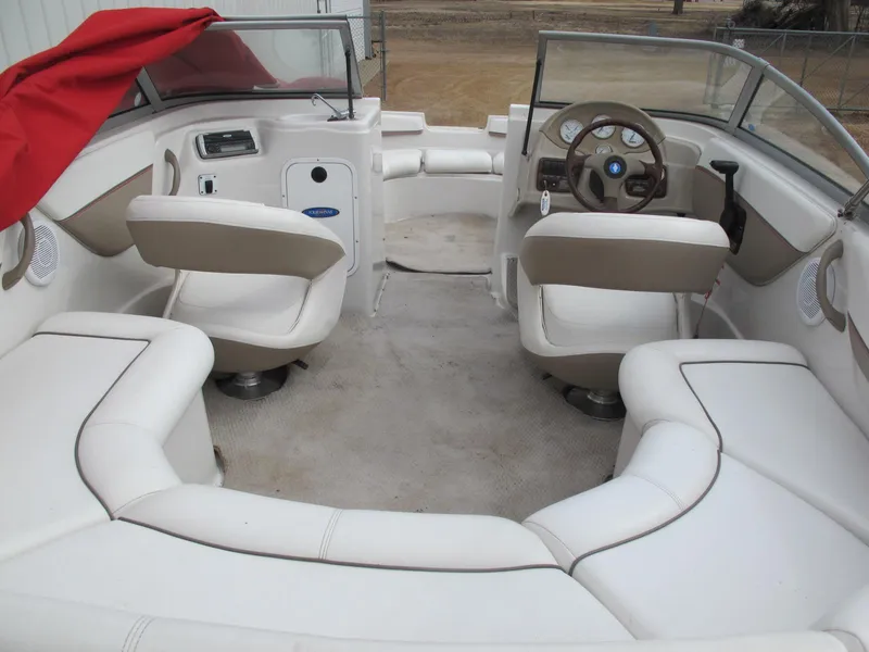 Slide: The Image of 2005 Four Winns 194 Funship boat interior with white seating and steering wheel. - 5