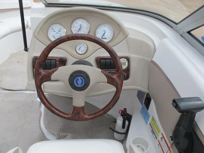 Slide: The Image of 2005 Four Winns 194 Funship dashboard with wood-accented steering wheel and gauges. - 8