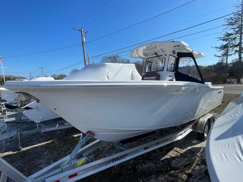 The Image of 2025 Sea Pro 292 Off Shore boat on trailer, displayed outdoors under clear blue sky. - 0