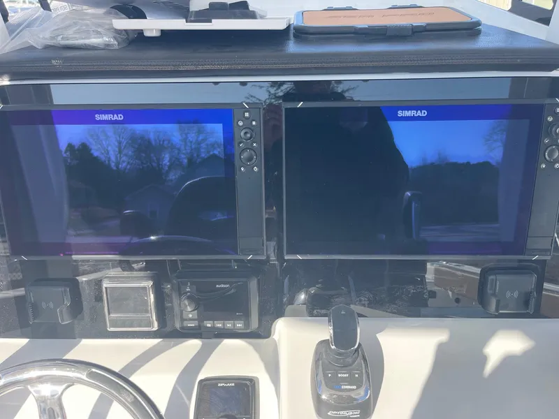 Slide: The Image of 2025 Sea Pro 292 Off Shore boat dashboard with dual Simrad displays. - 19