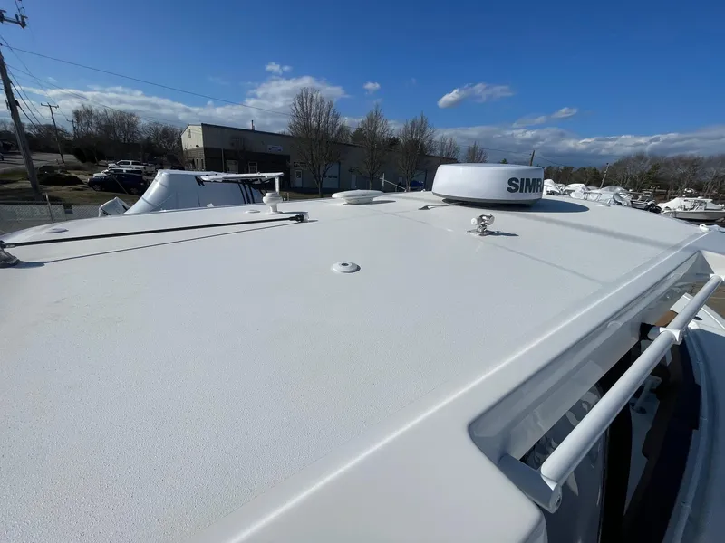 Slide: The Image of 2025 Sea Pro 292 Off Shore boat deck under clear blue sky. - 25