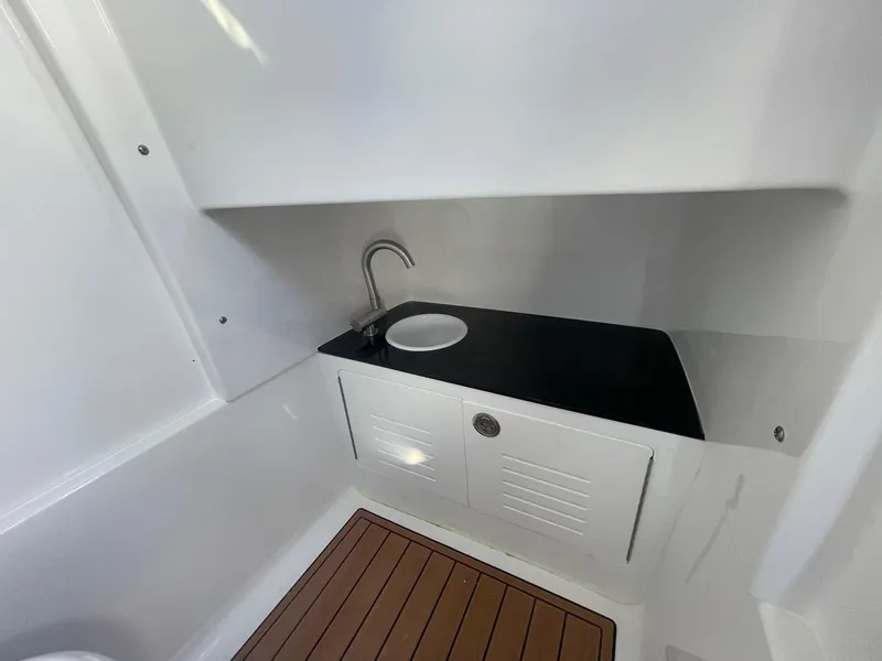 Slide: The Image of 2025 Sea Pro 292 Off Shore boat interior with sink and wooden flooring. - 28