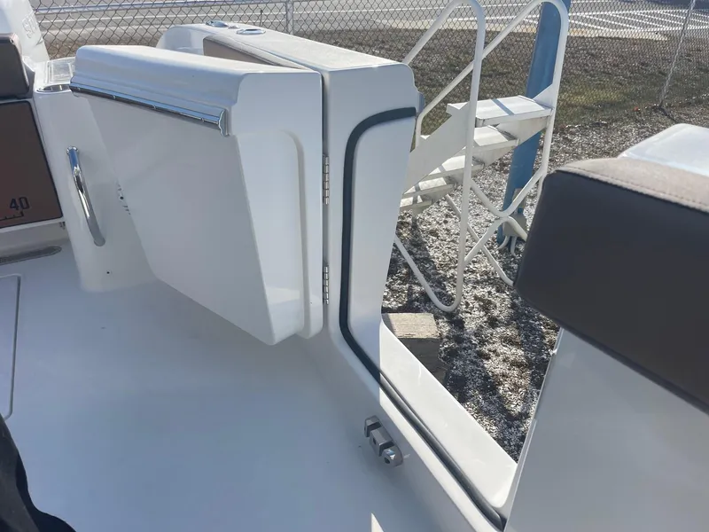 Slide: The Image of 2025 Sea Pro 292 Off Shore boat with open side door, showcasing sleek design. - 35