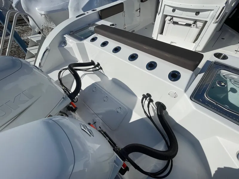 Slide: The Image of 2025 Sea Pro 292 Off Shore boat deck with Suzuki engines and fishing rod holders. - 4
