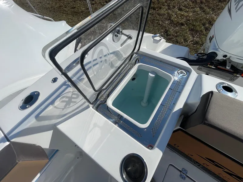 Slide: The Image of 2025 Sea Pro 292 Off Shore boat with open storage compartment and seating area. - 7