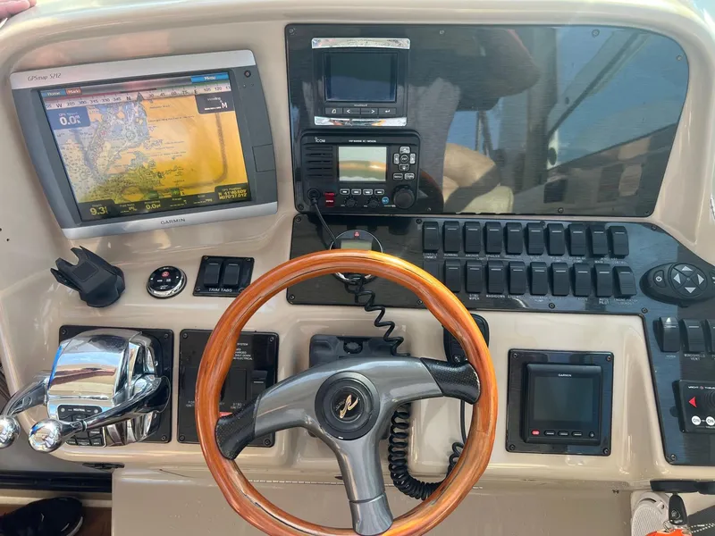 Slide: The Image of Control panel of a 2001 Sea Ray 340 Amberjack with navigation and communication equipment. - 11