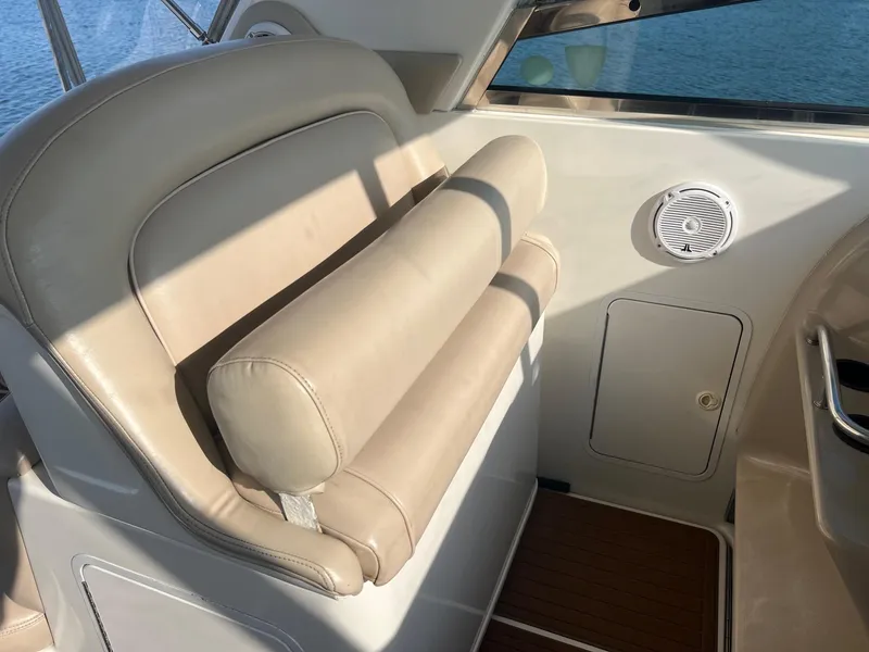 Slide: The Image of 2001 Sea Ray 340 Amberjack boat interior with beige seating and speaker. - 13
