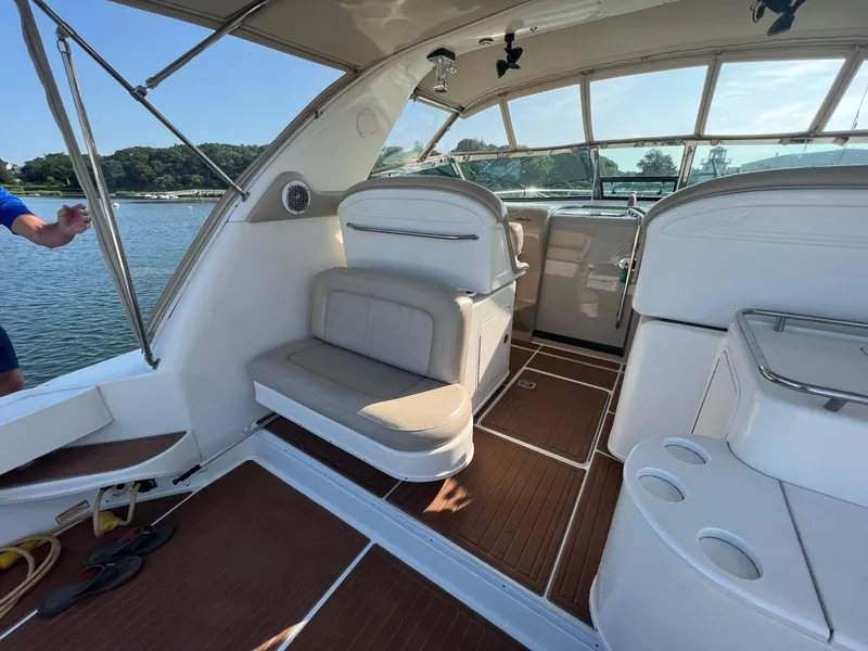 Slide: The Image of 2001 Sea Ray 340 Amberjack interior with seating and helm, docked on a sunny day. - 14