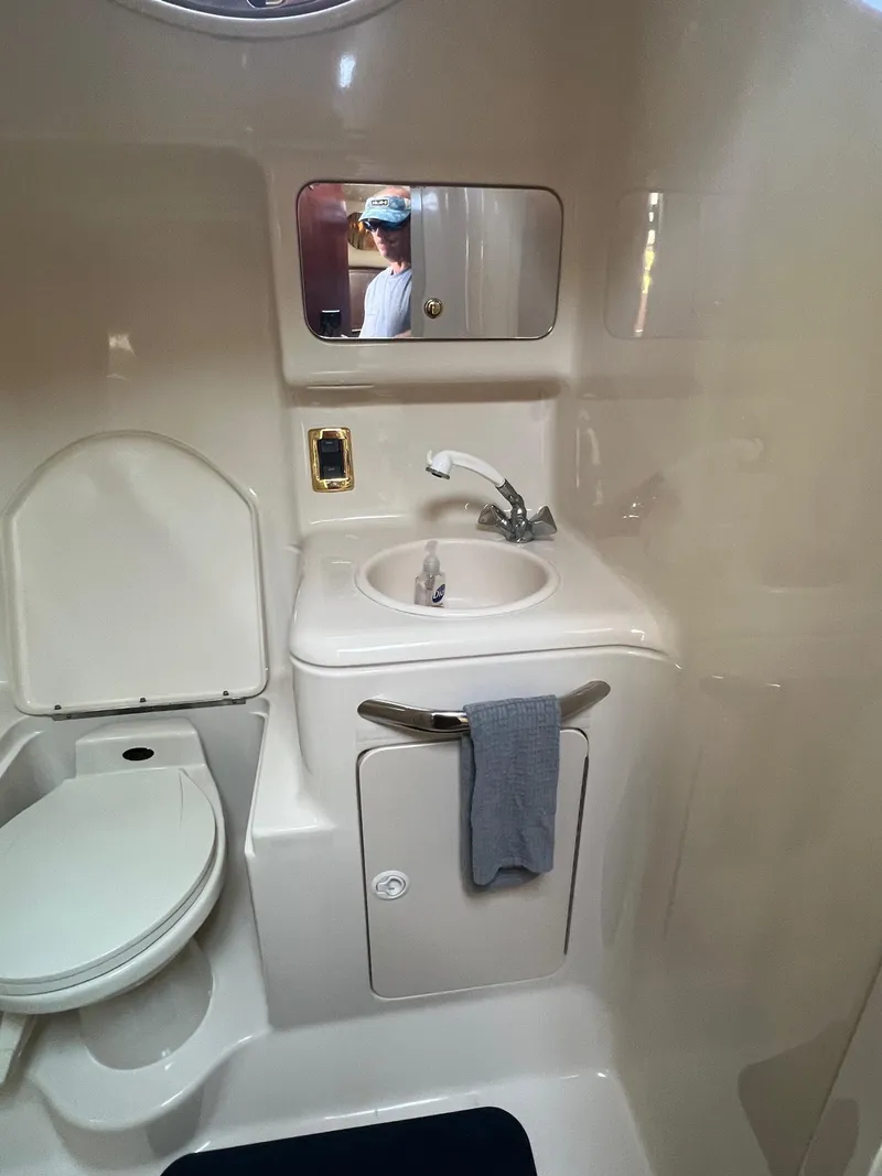 Slide: The Image of Bathroom interior of 2001 Sea Ray 340 Amberjack boat, featuring sink and toilet. - 21