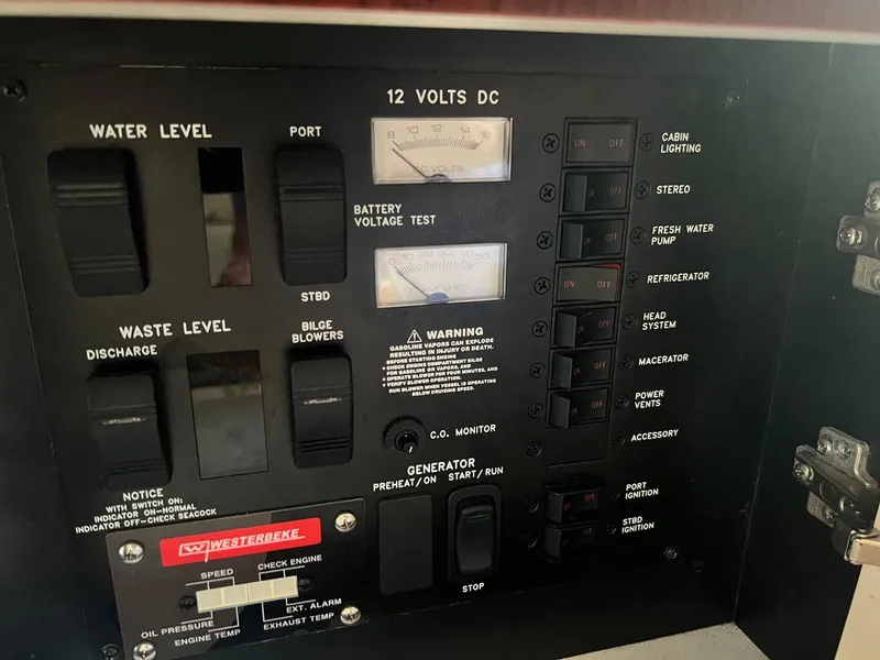 Slide: The Image of Control panel of a 2001 Sea Ray 340 Amberjack boat, featuring various switches and gauges. - 23