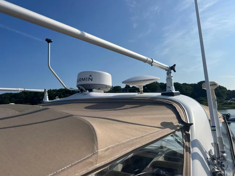 Slide: The Image of 2001 Sea Ray 340 Amberjack boat with Garmin radar, clear sky background. - 24