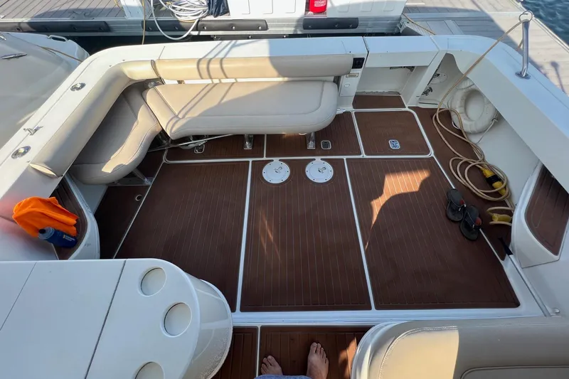 Slide: The Image of 2001 Sea Ray 340 Amberjack boat deck with seating, wood flooring, and dock accessories. - 28