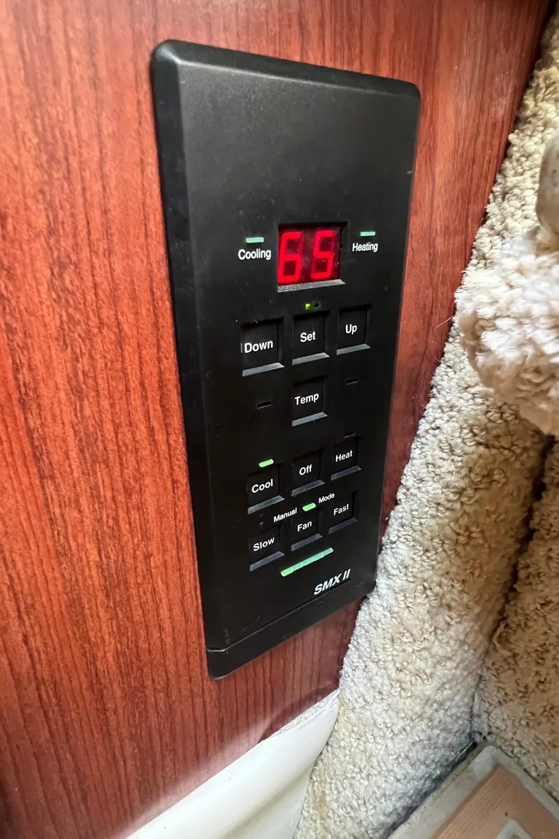 Slide: The Image of Control panel on 2001 Sea Ray 340 Amberjack boat, displaying temperature settings. - 29