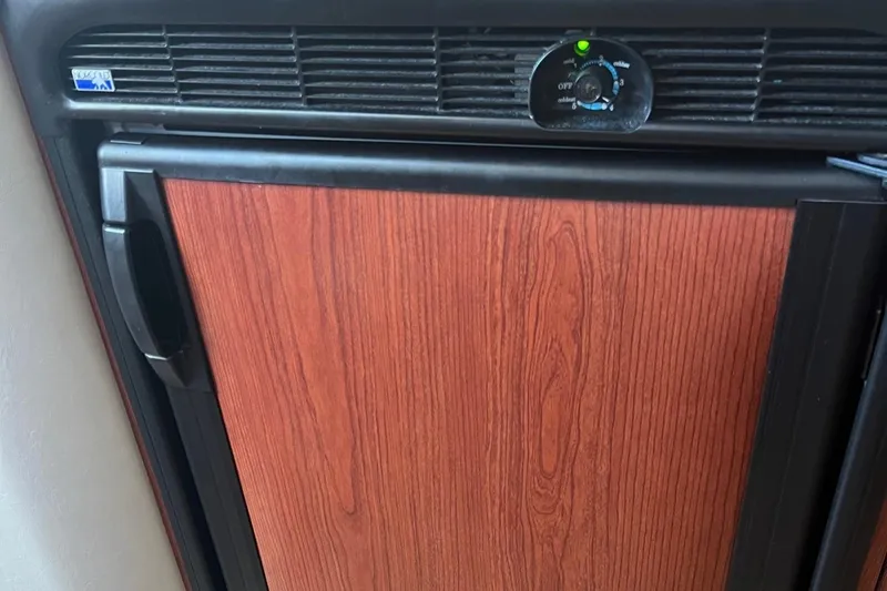 Slide: The Image of Wood-paneled refrigerator in 2001 Sea Ray 340 Amberjack boat interior. - 30